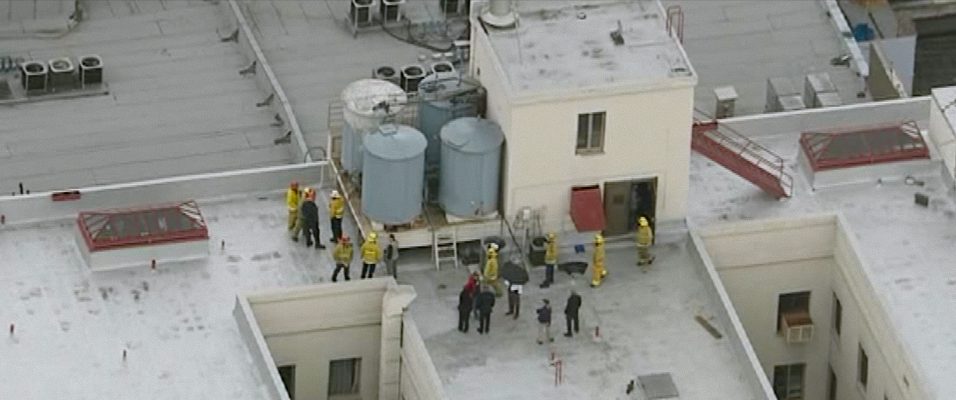 Firefighters and police officers on the Cecil hotel roof in episode 2 of Crime Scene: The Vanishing at the Cecil Hotel. c. Courtesy of Netflix © 2021